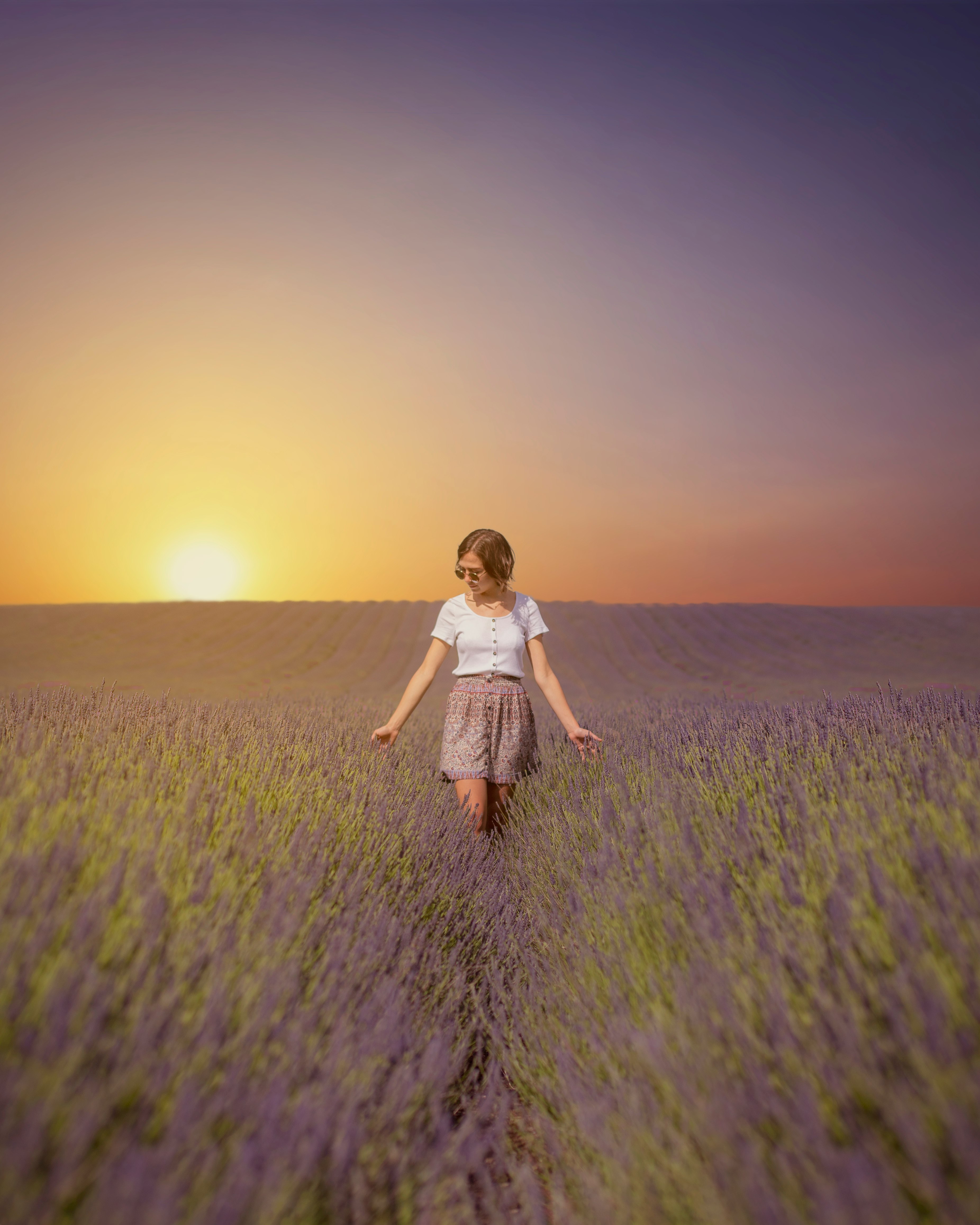 girl in white dress running on green grass field during daytime